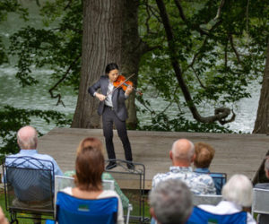 Violinist Sean Lee performs a free concert by the Damariscotta River in Newcastle during the 2023 Salt Bay Chamberfest. (Courtesy photo)