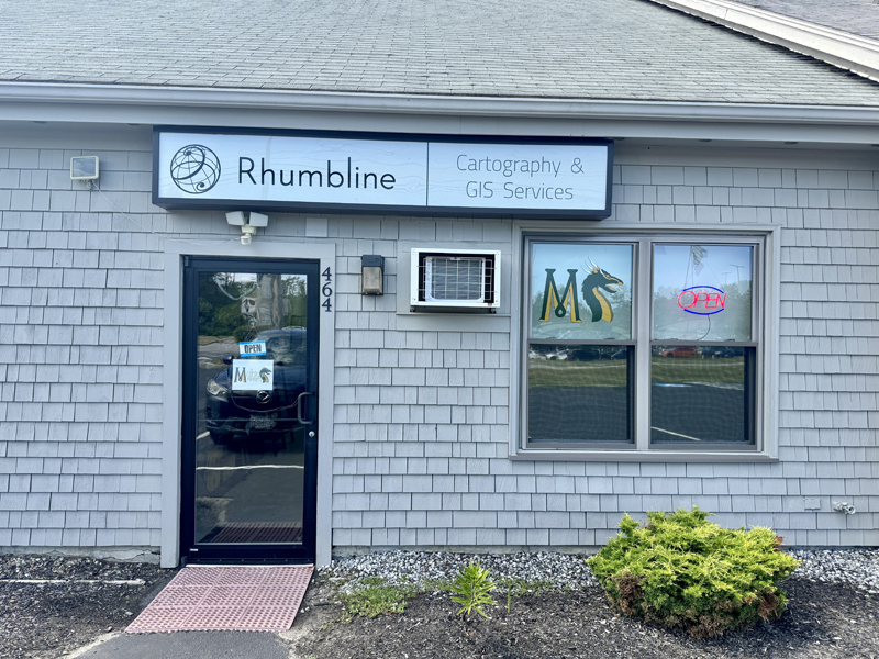 The storefront of Mythical Market tabletop game store and Rhumbline cartography and GIS services at 464 Main St. in Damariscotta on Saturday, July 20. While the businesses are separate, Forrest Meader, who opened the game store, is also the director of Rhumbline, a business his brother founded. (Johnathan Riley photo)