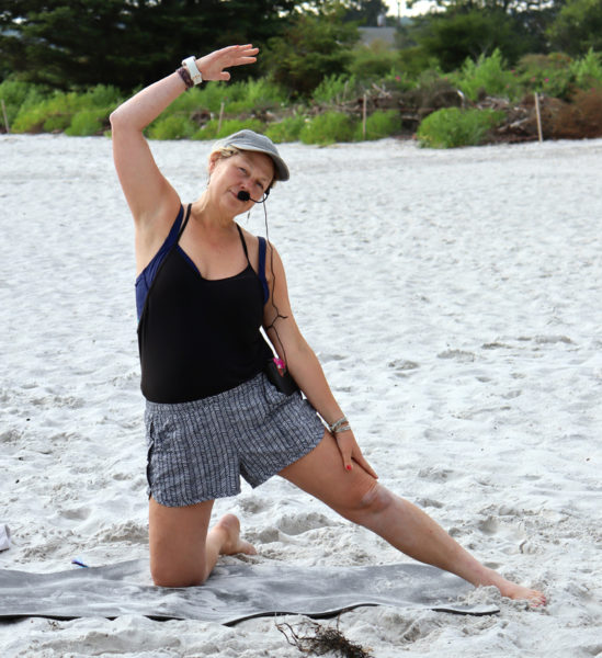 Damariscotta resident Sarah Plummer leads a yoga class on the beach at Pemaquid Beach Park in Bristol the evening of Tuesday, July 23. A music teacher, yoga instructor, and all-around active member of the community, Plummer said she strives to inspire every person she meets to connect with nature and reach their potential in mind, body, and spirit. (Piper Pavelich photo)