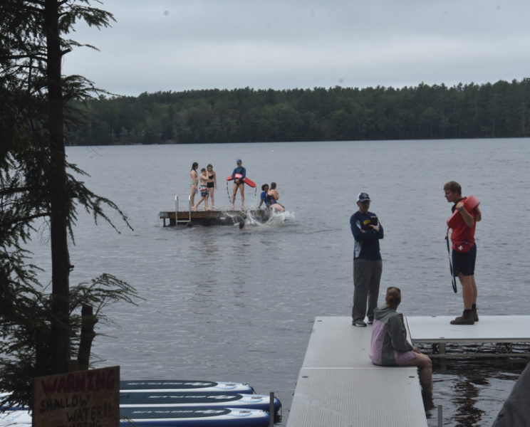 Campers swim, leap, and play in the water of Washington Pond on Monday, July 29, at RSU 40's free summer camp. Co-Director Sherry Casas said teaching swimming and providing opportunities for water activities are central to the camp's programming. "What this really is is opportunity ... A lot of the kids who come here have never swam before," Casas said. (Molly Rains photo)