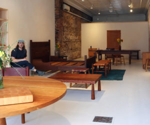 Bicyclette Furniture owner Brian Christopher sits amongst his creations in the business's new showroom at 78 Main St. in Wiscasset on Thursday, July 11. Christopher opened the showroom to the public on July 4. (Piper Pavelich photo)