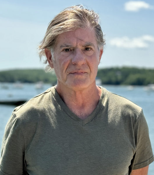 Award-winning journalist Robert Conlin stands in front of the Damariscotta River at the town landing on Friday, July 26. The Wiscasset-based author released his latest book The Lewiston Shooting: an all-American tragedy with Wild Blue Press on Tuesday, July 30. (Johnathan Riley photo)