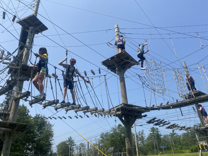 Guests climb through the ropes course at Monkey C Monkey Do on Sunday, July 28. The adventure park sees around 11,000-12,000 kids every season, many of whom are from camps, church groups, or after-school programs. (Frida Hennig photo)