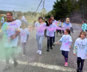 Participants walk through clouds of color during the You Are Deeply Loved Color Run. (Courtesy photo)