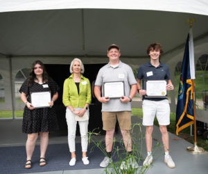 Pam Edwards presents Emily Boone, Lincoln Ball, and Conor Glasier with the Nobleboro Historical Society's scholarships. Boone, Ball, and Glasier are members of Lincoln Academy's class of 2024. From left: Emily Boone, Pam Edwards, Lincoln Ball, and Conor Glasier. (Photo courtesy Nobleboro Historical Society)