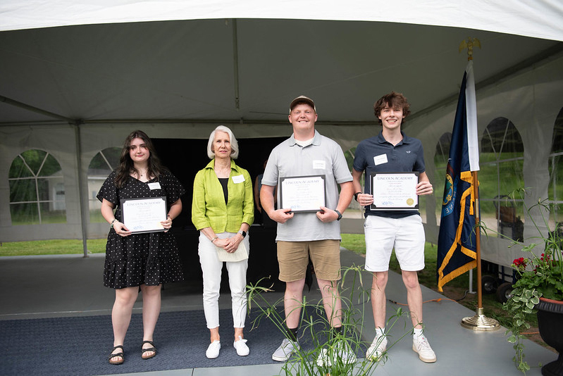 Pam Edwards presents Emily Boone, Lincoln Ball, and Conor Glasier with the Nobleboro Historical Society's scholarships. Boone, Ball, and Glasier are members of Lincoln Academy's class of 2024. From left: Emily Boone, Pam Edwards, Lincoln Ball, and Conor Glasier. (Photo courtesy Nobleboro Historical Society)