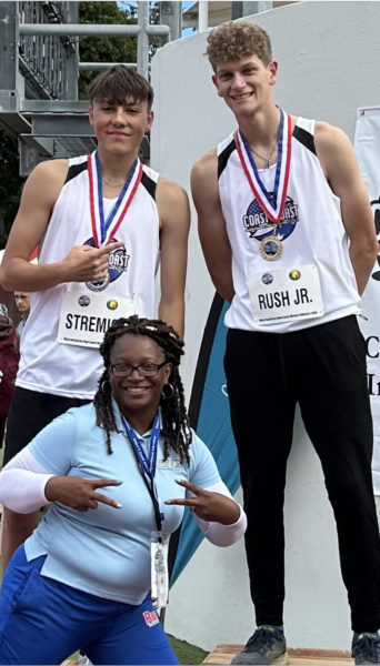 Will Rush (right) won the gold medal in the triple jump at the Coast2Coast International Meet in Gold Coast, Australia on Tuesday, July 16. Rush is pictured with USA teammate Stan Stremick (left) who won the silver, and his Coast2Coast jumping coach Nicole Lincoln. (Courtesy photo)