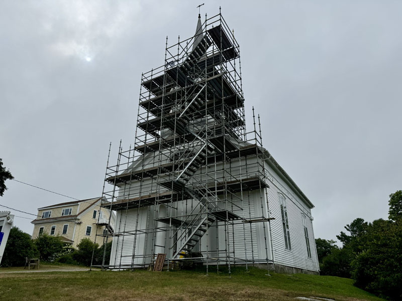 The Round Pond Meetinghouse, home of Helping Hands of Round Pond, adorned with scaffolding on Route 32 in Bristol on July 25. The scaffolding went up in April and came down the week of Aug. 12. (Johnathan Riley photo)