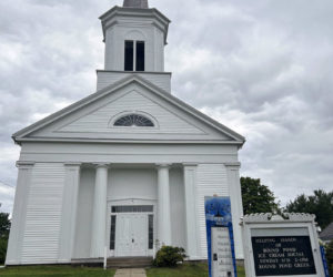 The Round Pond Meetinghouse stands against a cloudy sky on Tuesday, Aug. 20. The meetinghouse steeple, facade, and front porch were recently renovated to mitigate water damage. (Maia Zewert photo)