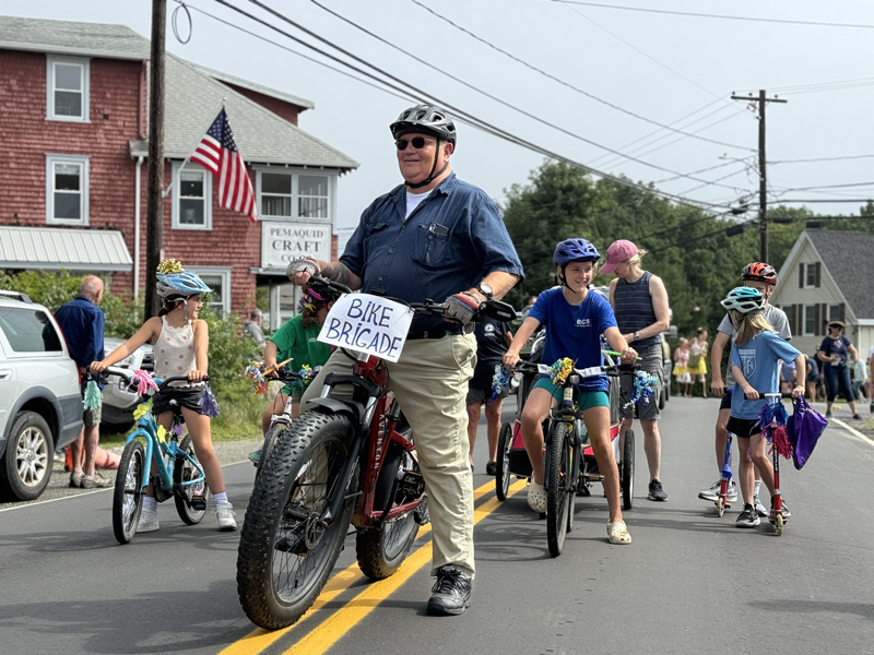 Former Bristol Fire Chief Paul Leeman leads a brigade of children on bikes during the Olde Bristol Days parade in New Harbor on Saturday, Aug. 10. The brigade entered the parade at Harbor Ice Cream on Route 130. (Johnathan Riley photo