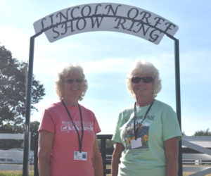 Claudene Northrup (left) and Claudia Orff-Reed, sisters from Jefferson, stand at the Lincoln Orff Show Ring, which is named for their father, who passed away in 2021. Orff was secretary at the Windsor Fair for more than 30 years and well known for the show steers he raised, trained, and showed with Orff-Reed and Northrup. (Molly Rains photo)