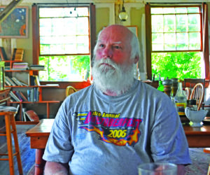 Bobo Hachmeister, of Waldoboro, pictured on July 11 in the former Paragon button factory on the Medomak River, where he has lived for 27 years. A woodworker, boater, and artist, Hachmeister has converted the factory to a studio and workshop where he undertakes projects including artwork, restoring boats, and rehabilitating the historic 1888 building. (Molly Rains photo)