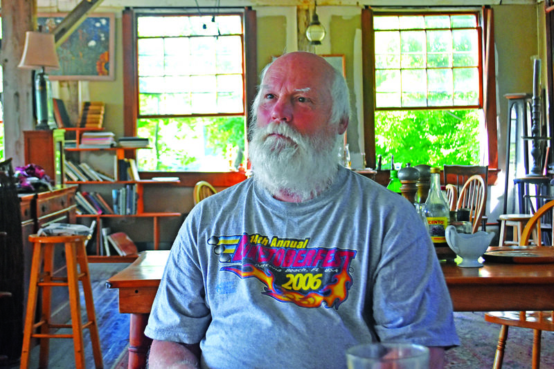 Bobo Hachmeister, of Waldoboro, pictured on July 11 in the former Paragon button factory on the Medomak River, where he has lived for 27 years. A woodworker, boater, and artist, Hachmeister has converted the factory to a studio and workshop where he undertakes projects including artwork, restoring boats, and rehabilitating the historic 1888 building. (Molly Rains photo)