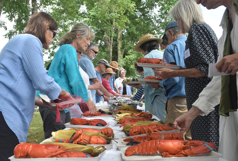 Volunteers and members of the Lincoln County Democratic Committee serve up steamed lobsters on Sunday, Aug. 4, at the committee's annual lobster bake. The event was catered by Jeff Hurd, of the Narrows Tavern and Cider Hill Farm, where the lobster bake was held. (Molly Rains photo)