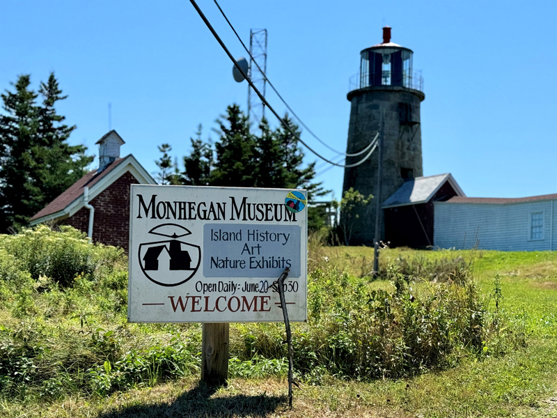 A walking stick rests against the sign for Monhegan Museum at the top of Light House Hill on Monhegan Island, on National Lighthouse Day, Wednesday, Aug. 7. Museum staff held a party the following day, celebrating the light stations 200th anniversary. (Johnathan Riley photo)