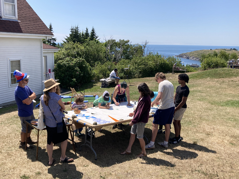 A group of lighthouse enthusiasts paints a celebratory bicentennial flag at the 200th anniversary of the light house on Monhegan Island on Thursday, Aug. 9 (Courtesy photo)