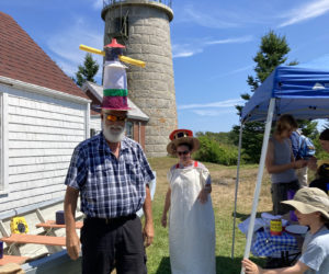 A group makes lighthouse hats during a celebration of the Monhegan light stations 200th anniversary on Thursday, Aug. 8. The celebration was put together by the Monhegan Museum, whom oversees the property the lighthouse is on. (Courtesy photo)