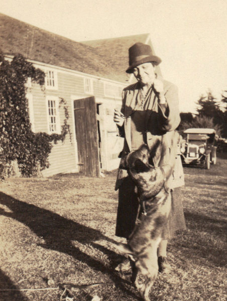 Frances Perkins plays with family dog Balto outside her Newcastle home. "The Brick House" was built in 1837 as a wedding gift to Perkins' grandparents, and Perkins visited in the summers as a child. (Photo courtesy Frances Perkins Center)