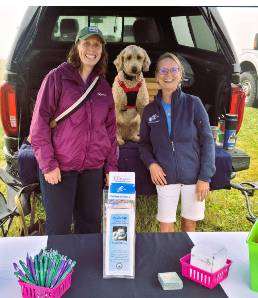 Leifa Gordon, Healthy Lincoln County staff member, Ginger Roberts-Scott, director of the Maine WIC Nutrition Program, and Gingers dog visit the Rockland Farmers Market. (Photo courtesy Healthy Lincoln County)