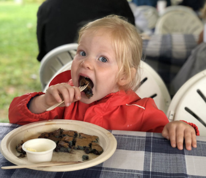 Eleanor Gerdts, of Texas, enjoys a bite of blueberry pancake at Fields Fields Blueberries during Wild Blueberry weekend, in Dresden Sunday, Aug. 4. The delicious sweet treats were a highlight of an event attended by hundreds of locals and visitors. (Sarah Masters photo)