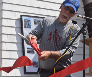 Bristol Parks and Recreation Commission Chair Clyde Pendleton cuts a ribbon to signify the completion of work to restore and fortify the bell house at Pemaquid Point Lighthouse Park in Bristol on Saturday, Sept. 14. The building was partially destroyed by back-to-back storms in January. (Nolan Wilkinson photo)