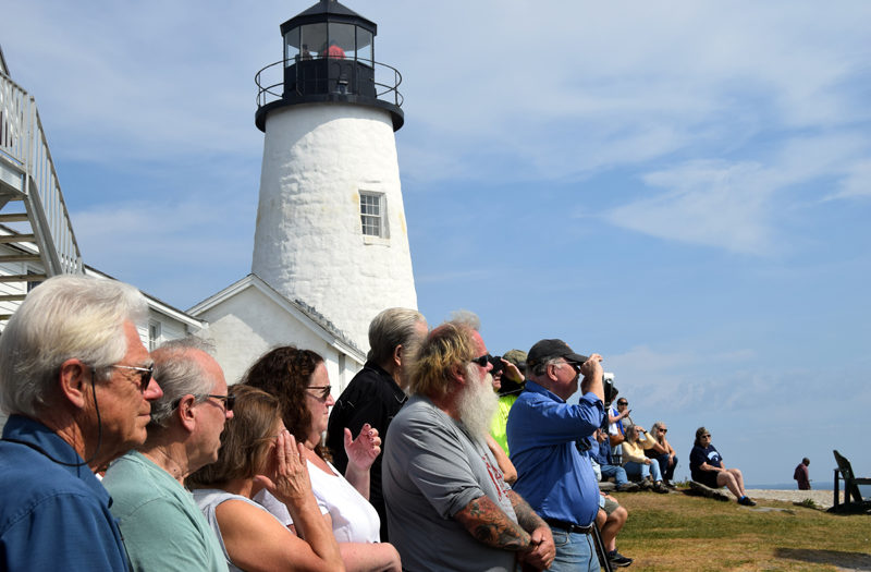 People watch as Bristol Parks and Recreation Commission Chair Clyde Pendleton (not pictured) speaks about the restoration of the bell house at Pemaquid Point Lighthouse Park in Bristol on Saturday, Sept. 14. (Nolan Wilkinson photo)