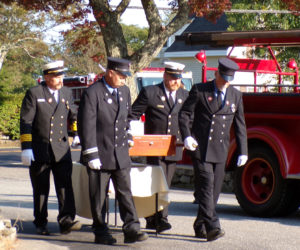 Ron Pendletons three sons and Ron's brother Clyde, all members of Bristol Fire & Rescue, transfer the ashes of the late fire chief from the 1944 Ford firetruck to a place of honor for the celebration of his life at the New Harbor fire station Friday, Sept. 13. From left: Jared, Scott, Brad, and Clyde Pendleton. (Sherwood Olin photo)