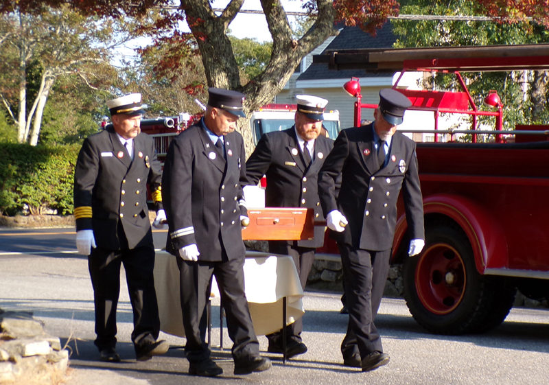 Ron Pendletons three sons and Ron's brother Clyde, all members of Bristol Fire & Rescue, transfer the ashes of the late fire chief from the 1944 Ford firetruck to a place of honor for the celebration of his life at the New Harbor fire station Friday, Sept. 13. From left: Jared, Scott, Brad, and Clyde Pendleton. (Sherwood Olin photo)