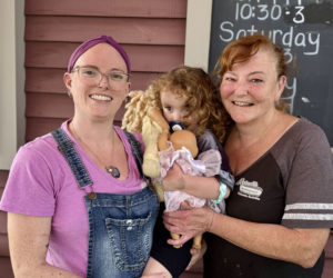 Julie Kaplinger (right) and her daughter, Kaydie Russell, both hold Russells daughter, Annaka, outside of Metcalfs Submarine Sandwiches in Damariscotta on Wednesday, Sept. 18. Kaplinger, who owns the sandwich shop, is also a music lover and antique car enthusiast. (Johnathan Riley photo)