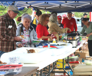 Attendees of the Waldoboro Republican Town Committee's third annual Great American Family Picnic serve themselves lunch the afternoon of Saturday, Sept. 7. On the menu for the event's meal were hamburgers, hot dogs, chips, and other sides, drinks, and desserts. (Piper Pavelich photo)