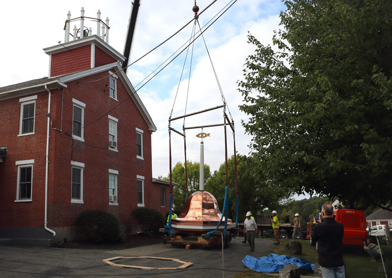 Lincoln Academy Technology Support Specialist Michael Johnson (right) takes photos while crew members from Keeley Crane Service, of Portland, work on lifting Lincoln Academy's new belfry to the roof the morning of Saturday, Sept. 7. The bell and belfry were removed in October 2023 due to structural issues. (Piper Pavelich photo)