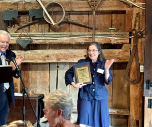 Stepping Stone Housing Inc. President Marilee Harris waves to the crowd after receiving the Small Business of the Year Award from the Damariscotta Region Chamber of Commerce and Information Bureau at its annual meeting and awards ceremony on Wednesday, Sept. 11. (Johnathan Riley photo)