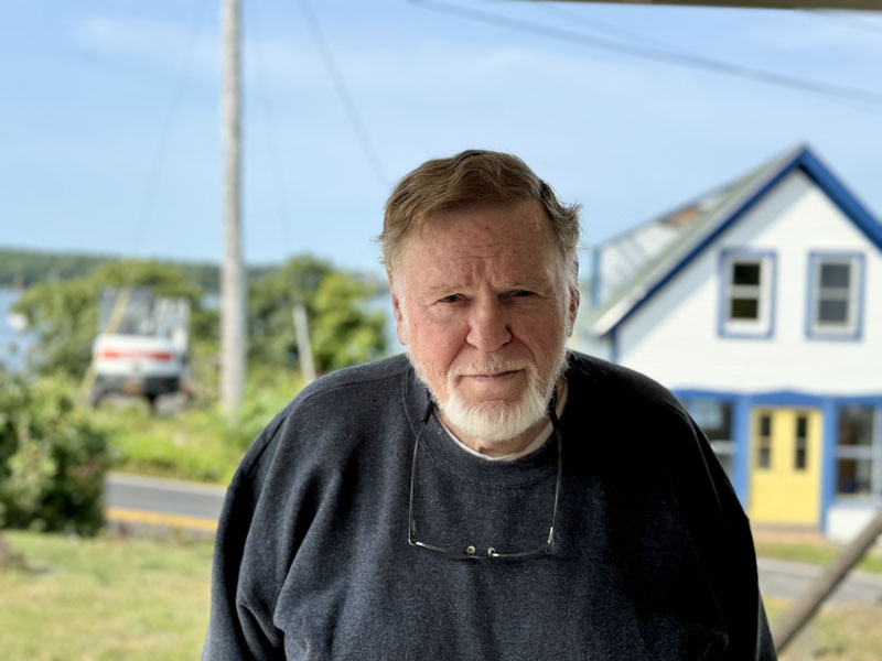 Larry Kelsey, of South Bristol, stands on the porch of the South Bristol Historical Society on Thursday, Sept. 12. Kelsey, who has served on the towns select board, planning board, and school committee, is the president of the historical society. (Johnathan Riley photo)