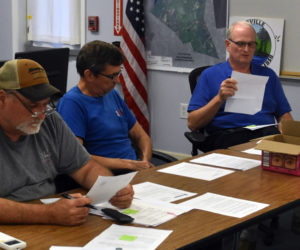 From left: Somerville Select Board members Willard Pierpont and Don Chase listen as Chair Donald Witmer-Kean reads a letter of resignation from former Somerville Town Clerk Samantha Peaslee on Wednesday, Sept. 18. Witmer-Kean, Peaslee, Somerville Treasurer and Tax Collector Sandra Devaney, and Somerville Road Commissioner Nicholas Fortune all announced their resignations during the meeting. (Molly Rains photo)