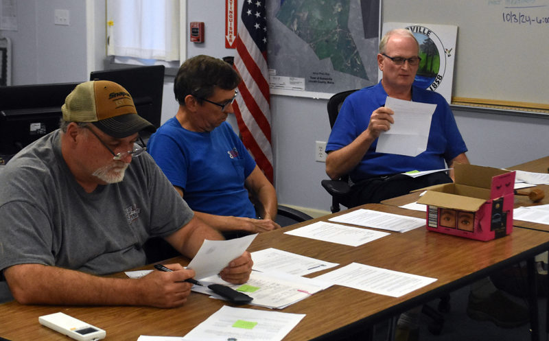 From left: Somerville Select Board members Willard Pierpont and Don Chase listen as Chair Donald Witmer-Kean reads a letter of resignation from former Somerville Town Clerk Samantha Peaslee on Wednesday, Sept. 18. Witmer-Kean, Peaslee, Somerville Treasurer and Tax Collector Sandra Devaney, and Somerville Road Commissioner Nicholas Fortune all announced their resignations during the meeting. (Molly Rains photo)