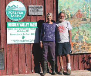 Bambi Jones (left) and David "Tracy" Moskovitz stand in front of a barn at Hidden Valley Farm in Whitefield the afternoon of Monday, Sept. 9. Hidden Valley Farm is one of four finalists for the 2024 New England Leopold Conservation Award, which celebrates achievement in conservation by agricultural landowners. (Piper Pavelich photo)