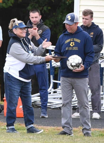 Medomak Valley boys soccer coach Brian Campbell is reconized for the 100th win of his coaching career, which was accomplished Thursday, Sept. 19 against Belfast, before the homecoming game against Lincoln Academy on Saturday, Sept. 21. (Mic LeBel photo)