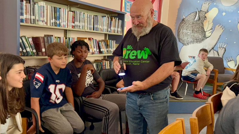 Summer readers react to a glowing scorpion under a blue light during a summer reading celebration on Sept. 12 at Nobleboro Central School. (Photo courtesy Nobleboro Central School)