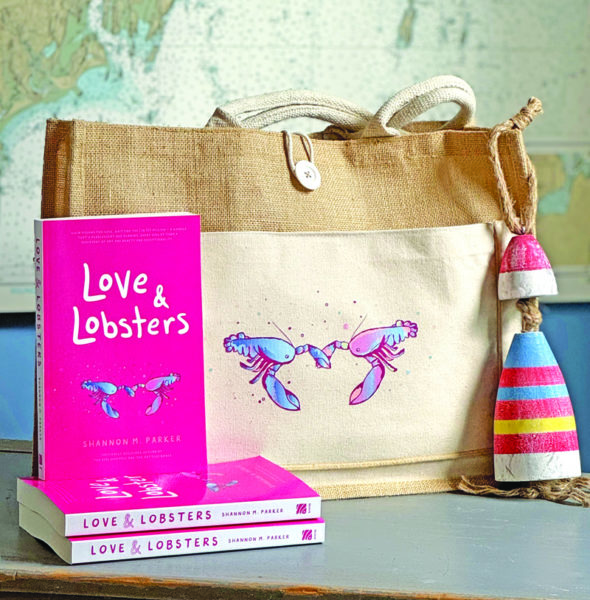 Copies of "Love & Lobsters," the third novel by Damariscotta author Shannon M. Parker, sit in front of a tote bag featuring the book's graphic. The book was released Tuesday, Oct. 1. (Photo courtesy Shannon M. Parker)