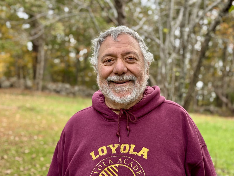 Nick Azzaretti stands in the yard of his Newcastle home on Thursday, Oct. 10. Azzaretti is a poet, teacher, and was the director of information technology at Lincoln Academy in Newcastle from 1993 until 2019. (Johnathan Riley photo)