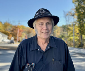 Michael Morrison, a photographer, mechanic, haunted house curator, and longtime fuel truck driver for Colby and Gale Inc., stands along Biscay Road in Damariscotta on Friday, Oct. 18. (Johnathan Riley photo)