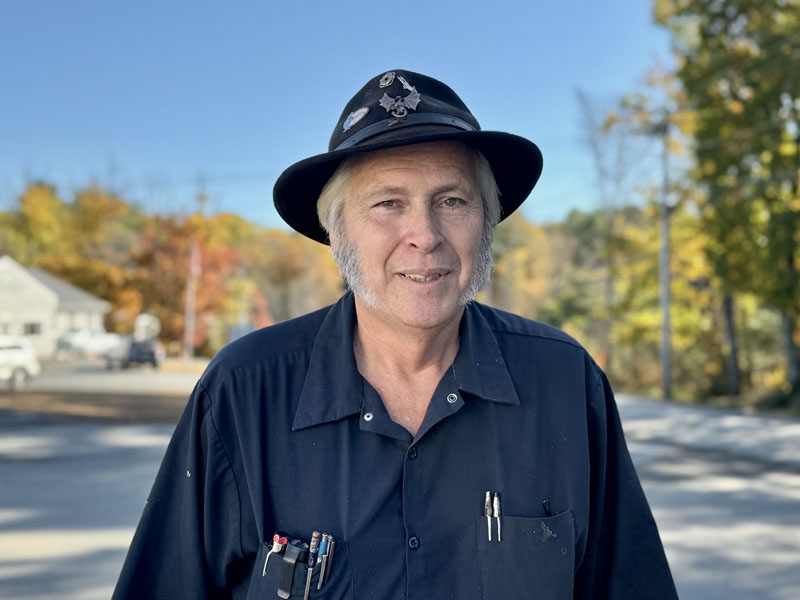 Michael Morrison, a photographer, mechanic, haunted house curator, and longtime fuel truck driver for Colby and Gale Inc., stands along Biscay Road in Damariscotta on Friday, Oct. 18. (Johnathan Riley photo)