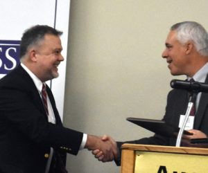 RSU 12 Superintendent Howard Tuttle (left) accepts the Maine Superintendent of the Year Award from last years winner, Jonathan Moody, at the Augusta Civic Center on Wednesday, Oct. 23. Public schools  the American public school system  is like no other in the world. Its the backbone of our democracy, Tuttle said. (Molly Rains photo)