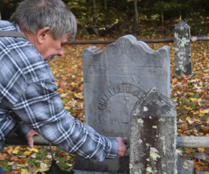 Neal Shuman, of Waldoboro, replaces a railing in front of a Civil War veteran's grave in the Oliver and Bernheimer Cemetery in North Waldoboro. Shuman, his two sons, and his daughter-in-law have helped maintain the site for the past 10 years, locating graves that were not recorded even in the records of the Waldoborough Historical Society, according to society President Bill Maxwell. (Molly Rains photo)