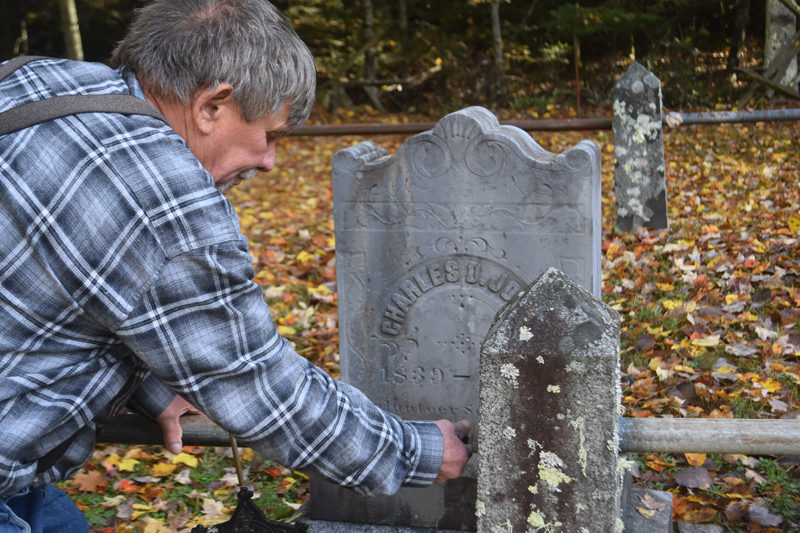 Neal Shuman, of Waldoboro, replaces a railing in front of a Civil War veteran's grave in the Oliver and Bernheimer Cemetery in North Waldoboro. Shuman, his two sons, and his daughter-in-law have helped maintain the site for the past 10 years, locating graves that were not recorded even in the records of the Waldoborough Historical Society, according to society President Bill Maxwell. (Molly Rains photo)