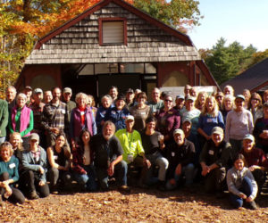 Friends old and new, supporters, associates, and honored guests gather at Hidden Valley Farm in Whitefield for the official presentation of the 2024 New England Leopold Conservation Award to David "Traci" Moskowitz and Bambi Jones on Saturday, Oct. 19. Jones, who is kneeling in the center of the group with Moskowitz, suggested a group picture would better celebrate the award, underscoring the value and power of community. (Sherwood Olin photo)