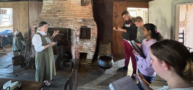 Louise Miller provides a guided tour for Wiscasset Middle High School students at the historic Chapman-Hall House in Damariscotta Sept, 18. Students DAntae Dawkins, Yashaswini Dikonda, Gabriella Dotson, and Spencer Smith-Pinkham study the unique characteristics of the colonial brick oven. (Photo courtesy Wiscasset Schools)