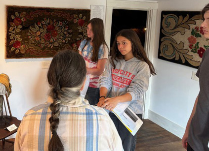 Wiscasset Middle High School AP United States history students Xoe Morse, Ijesity Rhinebolt, and Elijah Bouchard listen to Lincoln County Historical Association Education Director Louise Miller during a tour of the 1754 Chapman-Hall House in Damariscotta Sept. 18. (Photo courtesy Wiscasset Schools)