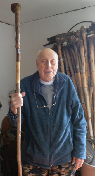 Errol T. Clark with a bucket full of gray birch walking sticks he made. (Paula Roberts photo)