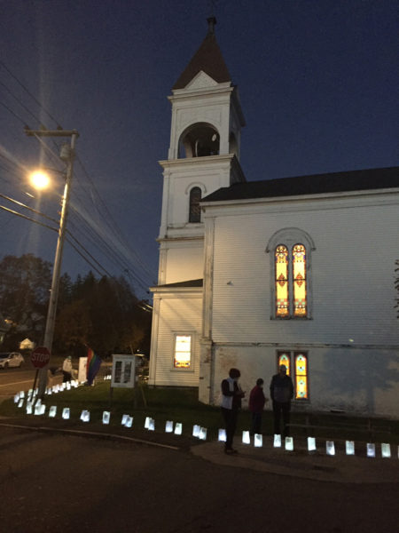 Attendees light luminaires at the Broad Bay Congregational Church in Waldoboro. (Courtesy photo)